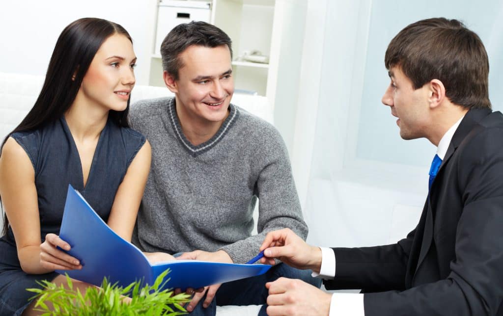 An insurance agent discussing a policy with clients.