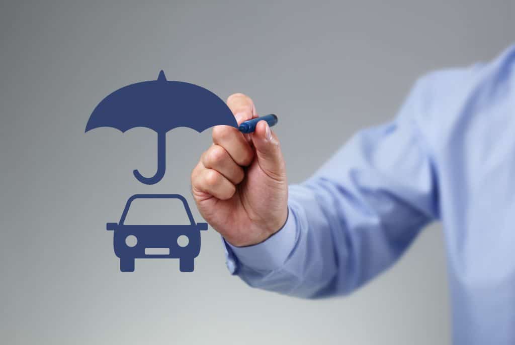 Insurance agent drawing an umbrella above a family car concept for car insurance, protection, security and finance
